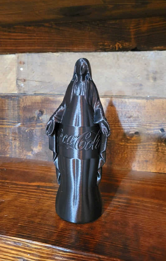 Black Our Lady of the Corner Store figurine on a wood surface