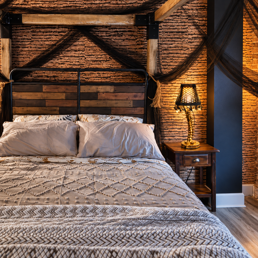 Gold spine table lamp with a solid black lampshade retaining band — styled bedroom image