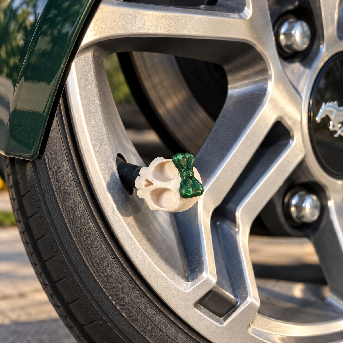 Styled color preview: cream skull valve cap with a green bow on a silver wheel beside emerald bodywork