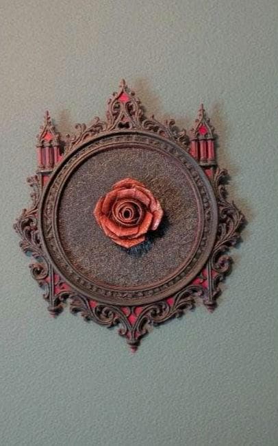 Red rose in an ornate gothic frame