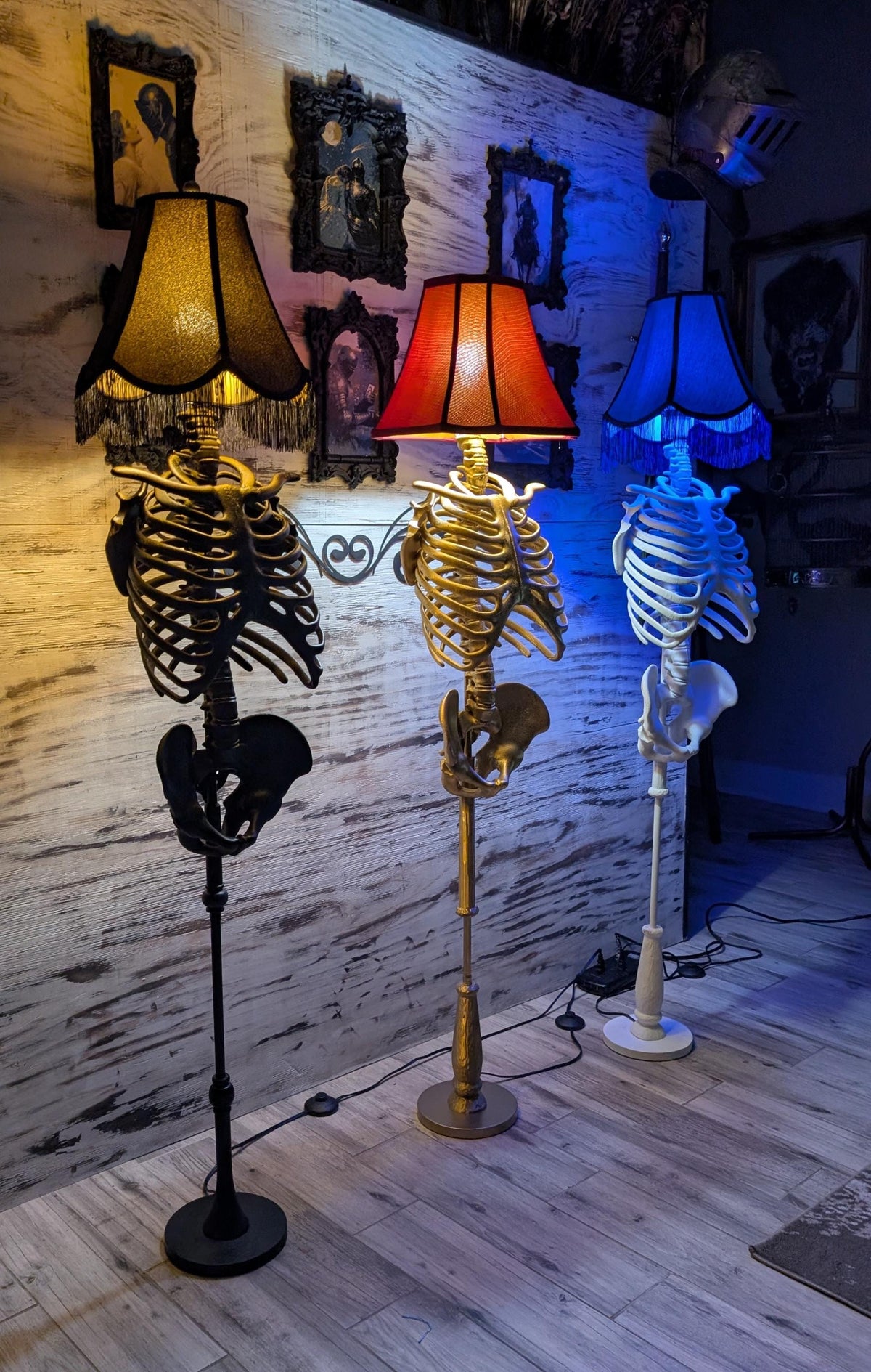 Black, gold, and white 3D-printed spine lamp bodies being handcrafted in the Cozy AF Sweatshop studio.